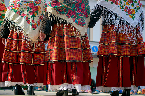 Women in Belarusian folk costumes. Embroidered dresses and painted scarves.