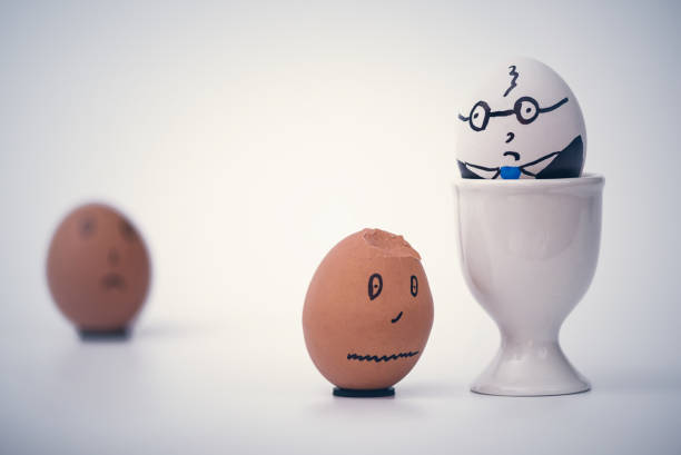 istock Two eggs white boss and black employee.  Racial discrimination on the workplace 1136987243