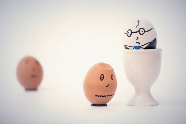 istock Two eggs white boss and black employee.  Racial discrimination on the workplace 1136987707