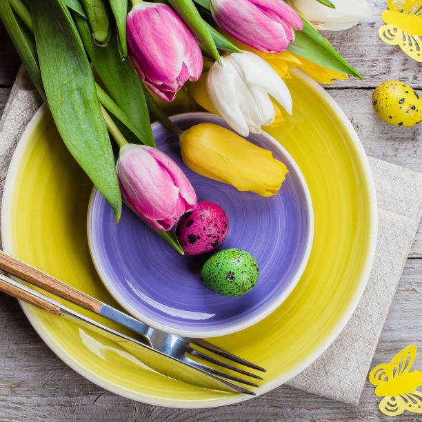 istock Easter table setting with spring tulips and cutlery. Holidays background. Top view, flat lay. copy space 1136988443