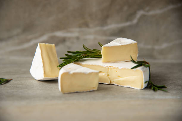 istock Cheese camembert or brie with fresh rosemary 1136988582