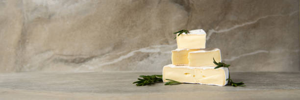 istock Cheese camembert or brie with fresh rosemary 1136988584