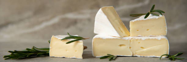 istock Cheese camembert or brie with fresh rosemary 1136988602