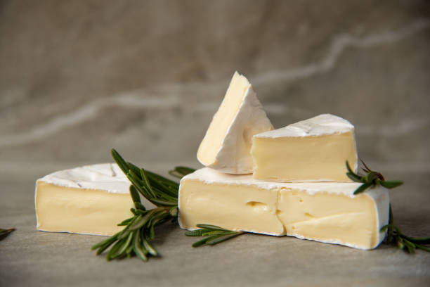 istock Cheese camembert or brie with fresh rosemary 1136988714