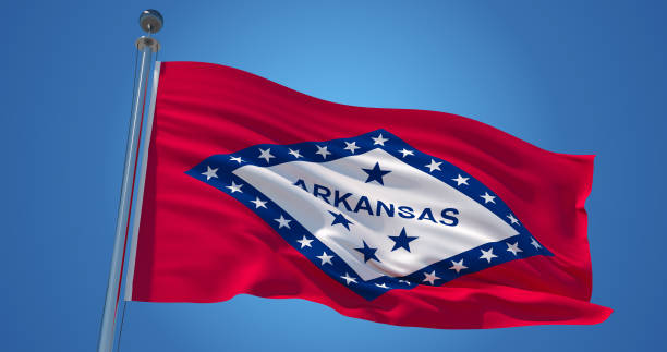 istock Arkansas flag on clear blue sky, patriotic background. 3d illustration 1136995071