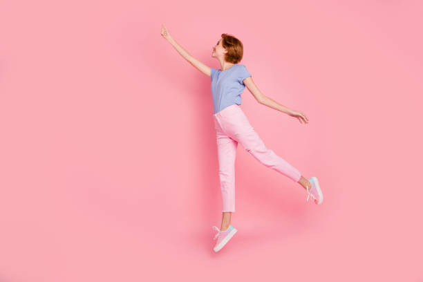 Full length body size profile side view of her she nice cute charming attractive cheerful girl wearing casual wind blows having fun holding invisible parasol isolated on pink pastel background