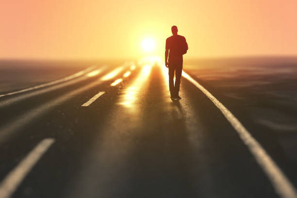 man goes on an empty road - one man only imagens e fotografias de stock