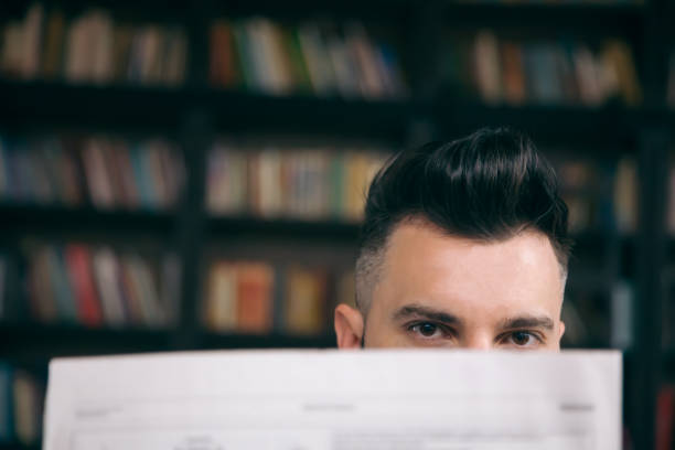 istock Young businessman with newspaper in cafe 1137004270