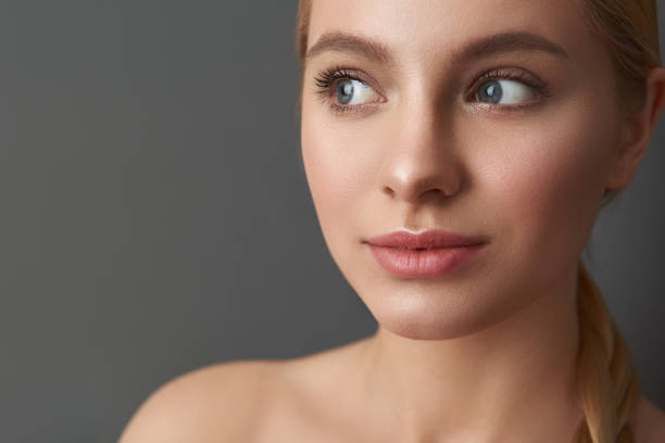 istock Close up of curious lady with bare shoulders standing and smiling 1137004781