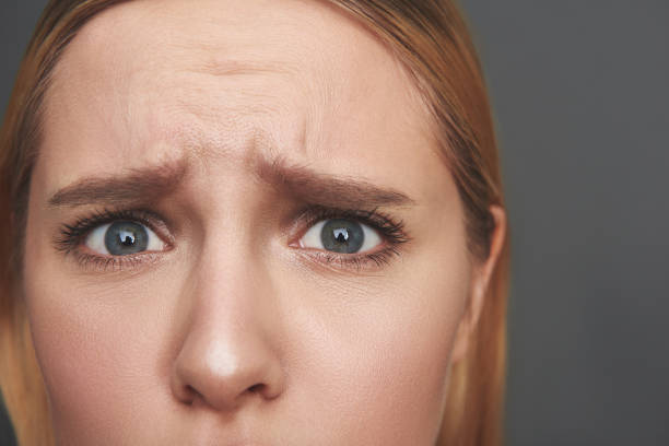 istock Close up of woman forehead and scared eyes 1137004842