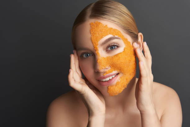 istock Calm woman touching her temples while having orange mask on the face 1137006266