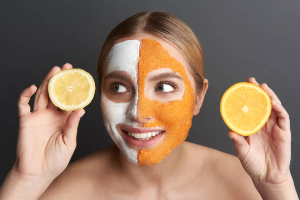 istock Funny lady holding lemon and orange slices and smiling 1137006285