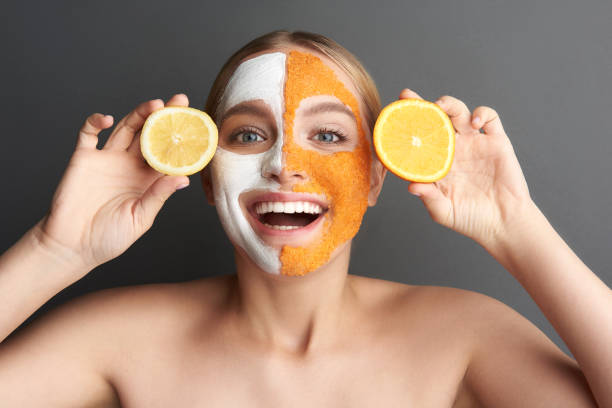 istock Excited woman with bare shoulders showing lemon and orange 1137006287