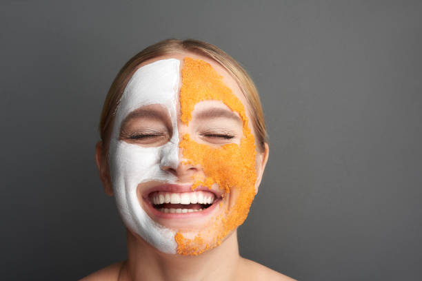 istock Woman with face mask revealing her teeth while smiling 1137006308