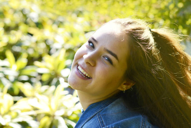 istock Happy young woman laughing outdoors 1137006421