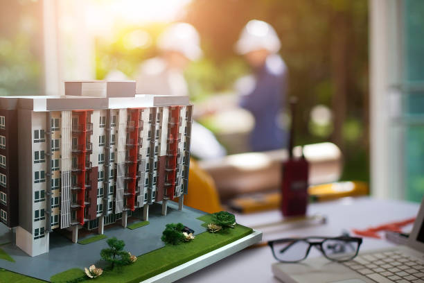 istock Concept Agreement between the employer and architect Nick and desk of Architectural project in construction site or office building  and Building models 1137007494