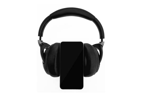 istock Black headphones and mobile phone isolated on a white background 1137008211