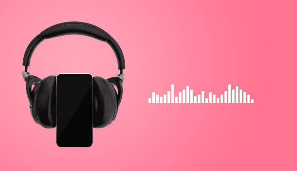 istock Wireless headphones with smartphone on pink background 1137008217