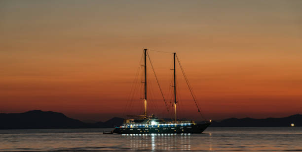 istock Illuminated modern yacht at sunset in Andaman sea 1137010826