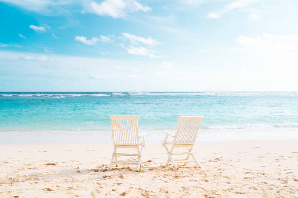 istock Bali, Bukit. Two white chairs on the beach 1137010925