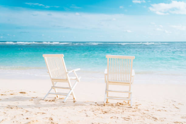 istock Bali, Bukit. Two white chairs on the beach 1137010928
