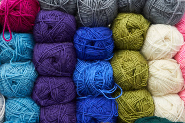 istock Threads for knitting different colors on the shelf in the store. Close up 1137011582