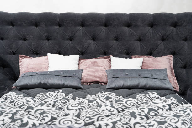 istock Bed with a large gray soft headboard and pillows. Close-up 1137011596