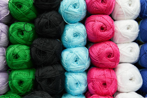 istock Threads for knitting different colors on the shelf in the store. Close up 1137011636