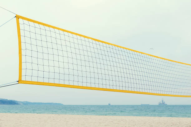 istock Yellow volleyball net on a sea shore Summer time No people Selective focus 1137012888