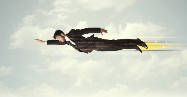 happy business man flying fast on the sky between clouds - men businessman jumping levitation imagens e fotografias de stock