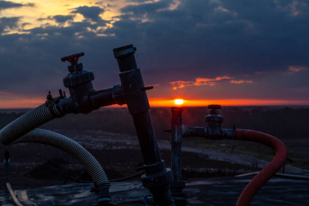 Sunrise over a Landfill showing a methane collection pipeline stock photo