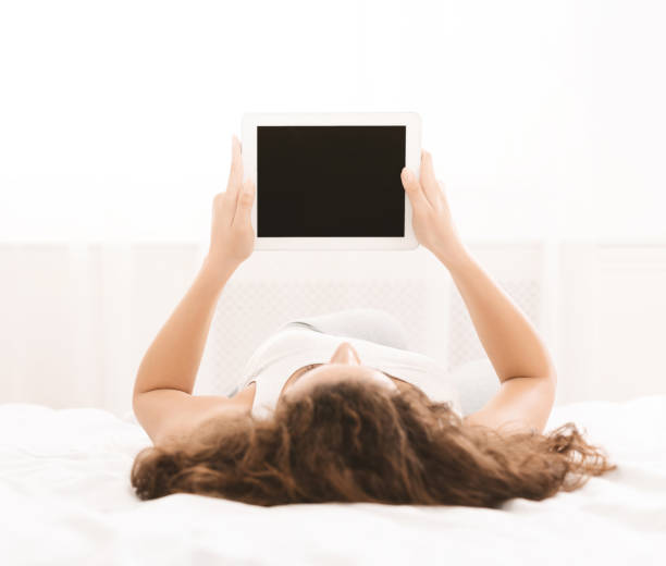 istock Young girl holding digital tablet with blank screen 1137015579
