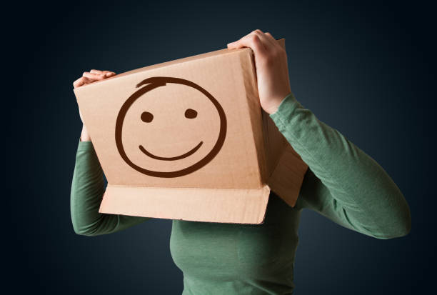 istock Young girl gesturing with a cardboard box on her head with smiley face 1137015773