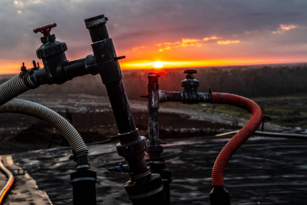 Sunrise over a Landfill showing a methane collection pipeline stock photo