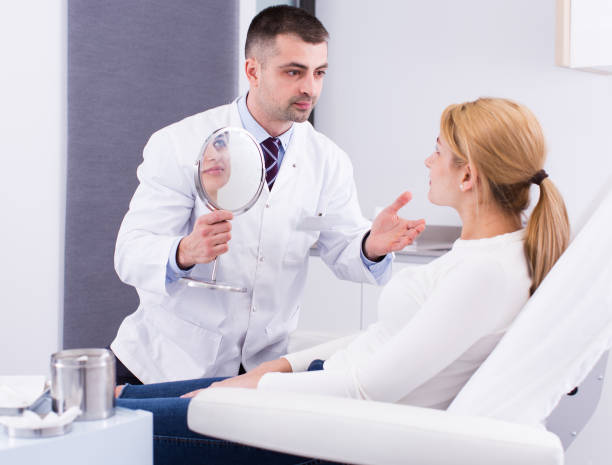 istock Cosmetologist examining female face 1137017120