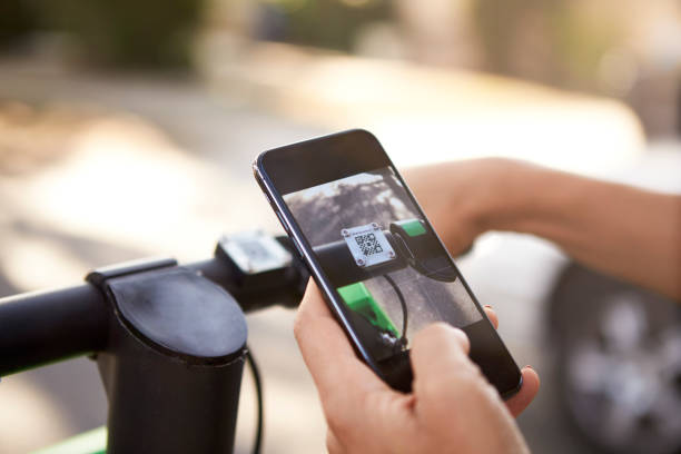 istock Close up of woman's hands using smartphone while riding on an electric scooter,detail 1137017352