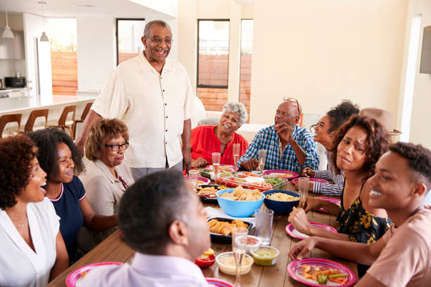 istock Three generation black family sitting at dinner table celebrating together,close up 1137018483