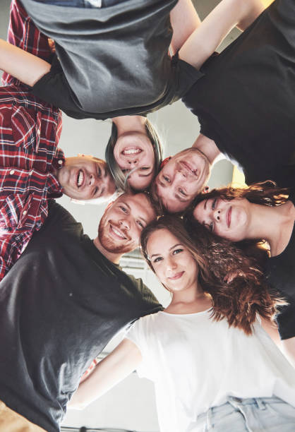 istock A large group of smiling friends hugging together. 1137018545