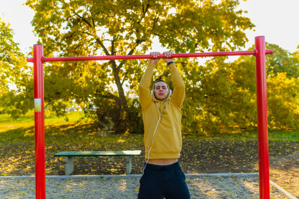 istock Young Muscular Male Athlete Doing Pull-Up Exercises In The Park 1137018753