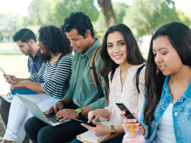 istock Beautiful college student sitting with friends 1137019997