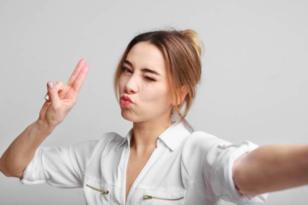 istock Joyful woman making selfie and having fun over gray background 1137020174