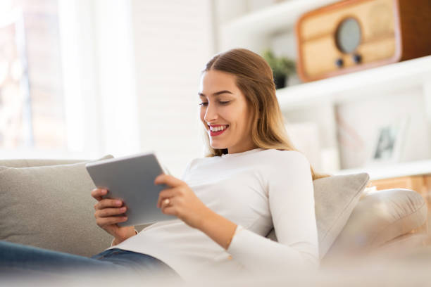 istock Young woman using digital tablet at home 1137020283