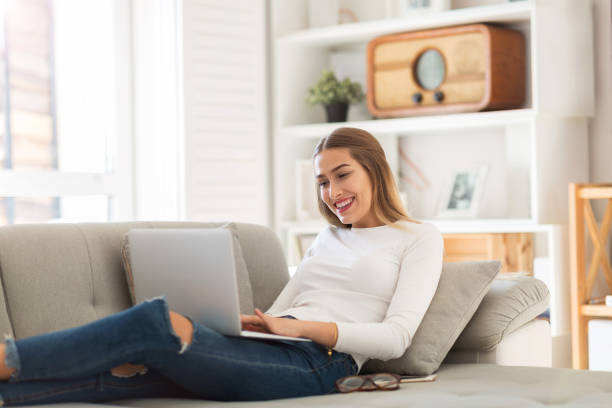 istock Young woman using her laptop at home 1137020288