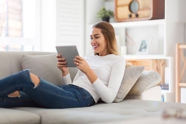 istock Young woman using digital tablet at home 1137020399