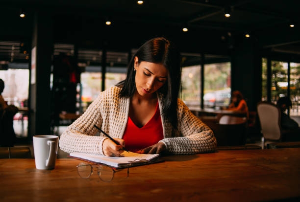 istock Young Brunette Woman is Working in the Cafe 1137021473