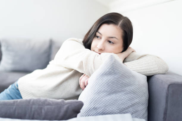 istock Young sad millennial girl, resting on her sofa 1137021547