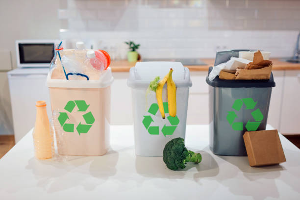 istock Waste sorting at home. Protect the environment. Colorful garbage bins with recycling icon full of plastic, food, paper on the table close-up 1137022292
