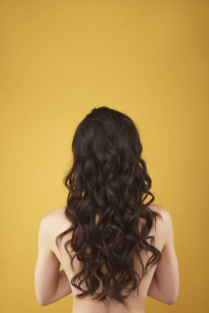 istock Back side portrait graceful woman with curly hairs 1137023778