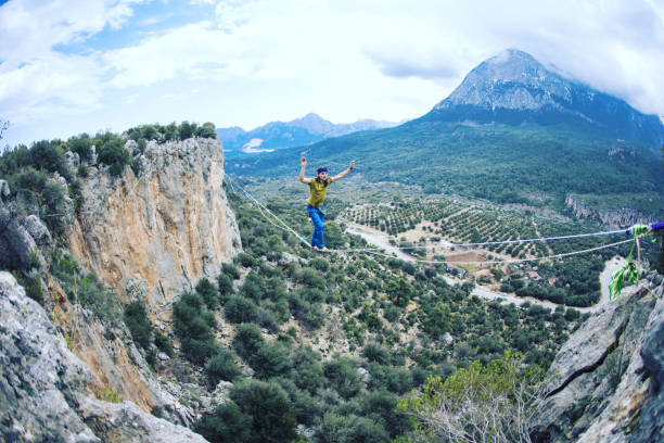 istock Man balancing on the rope concept of risk taking and challenge. 1137026504