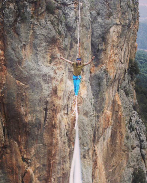 istock Man balancing on the rope concept of risk taking and challenge. 1137026512
